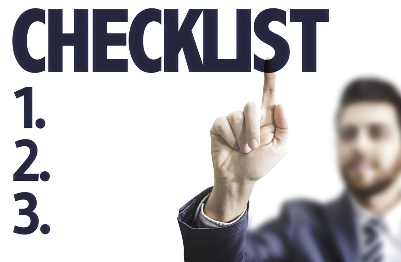 Business man pointing the text: Checklist